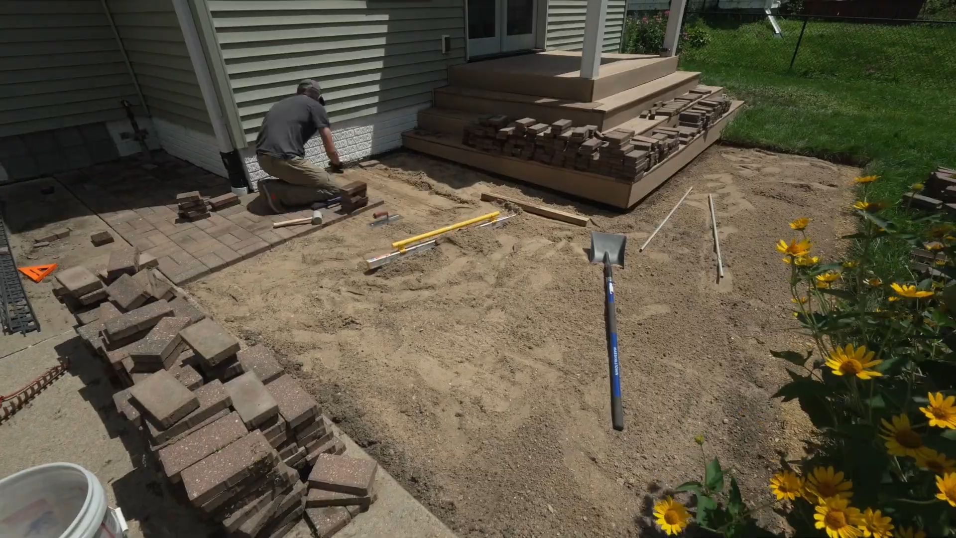 man laying brick pavers